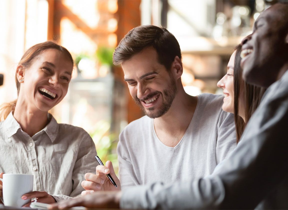 Accountants smiling and laughing during a finance meeting