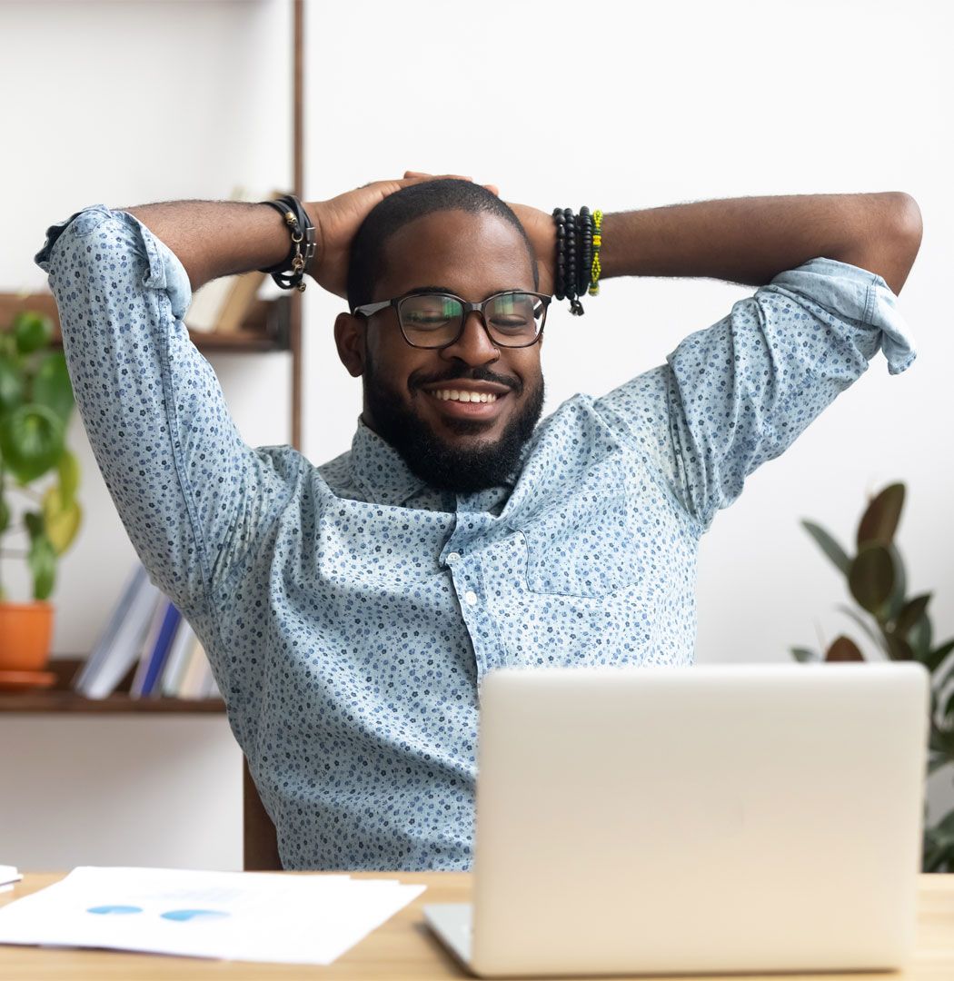Business owner smiling at their finance options on a laptop