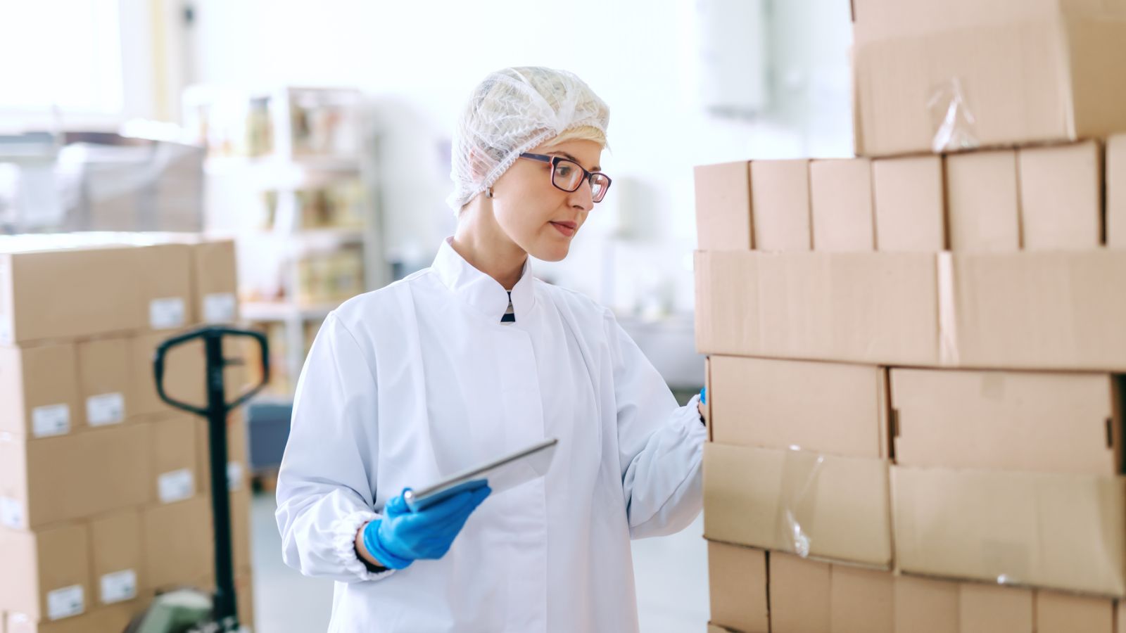 Worker quality checking boxes of stock