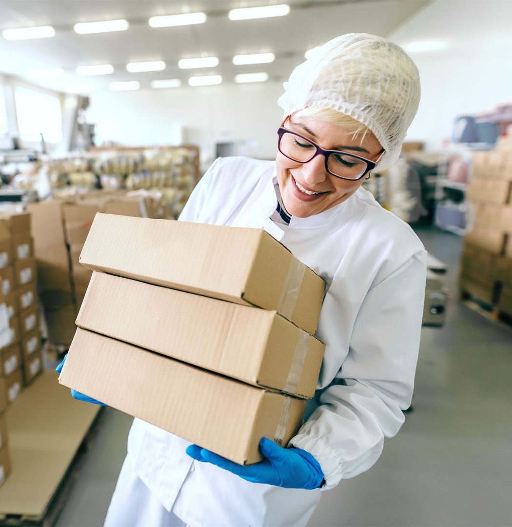 Employee carrying boxes in a warehouse