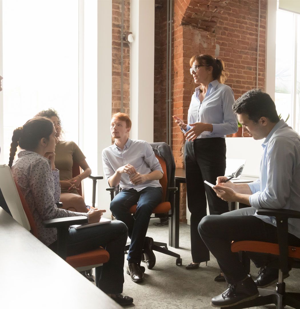 Accountants in a group meeting taking notes